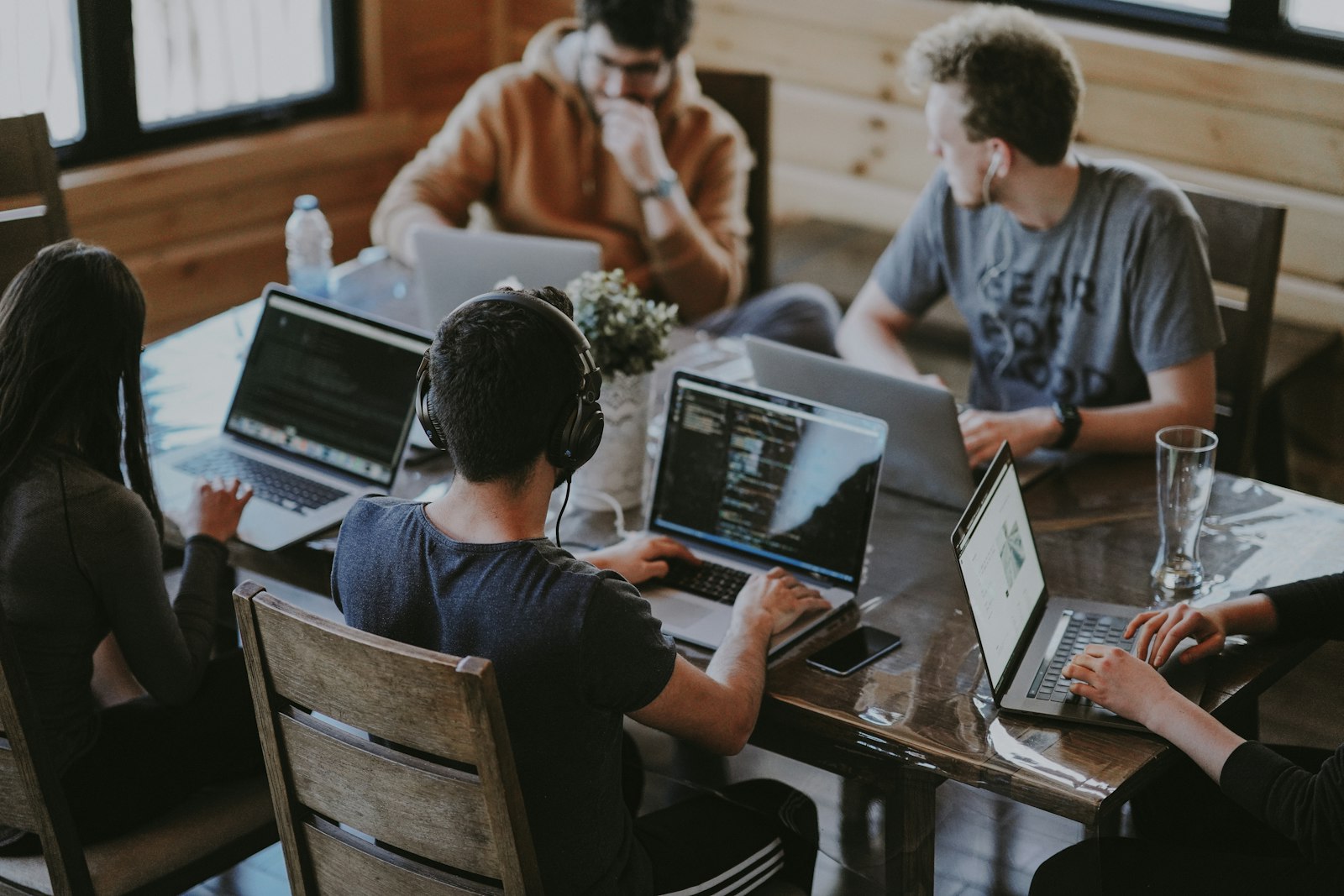 Avisha Global team members working together on laptops around a shared table