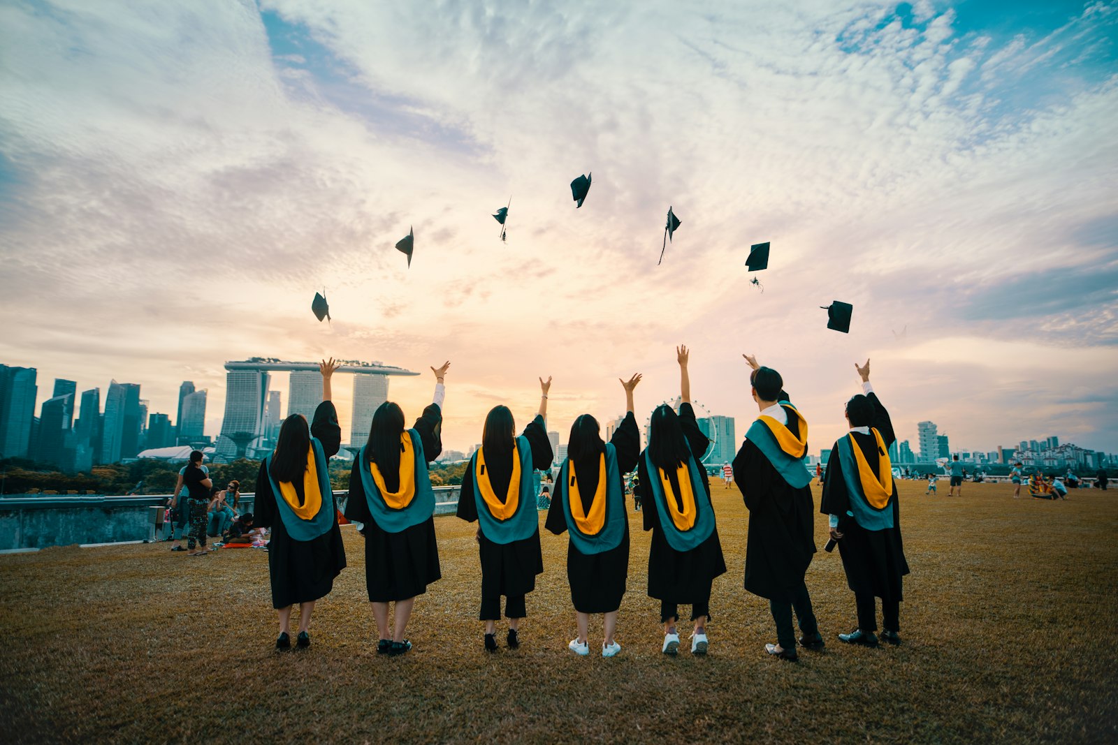 Graduating students celebrating against a city skyline, representing outcomes from AI-native learning